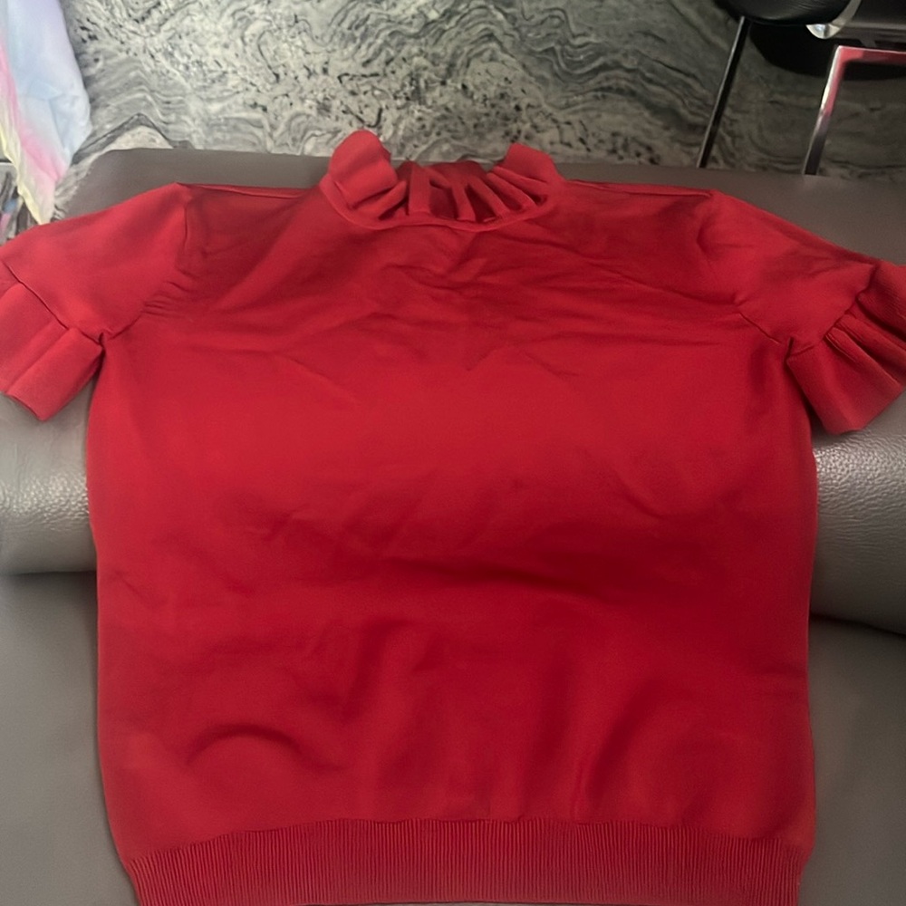 Bebe rich red color sweater like top Size S with ruffles on neck & arms